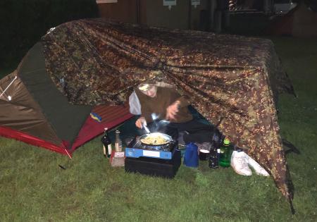 night two cooking while one person stays warm and dry in the tent