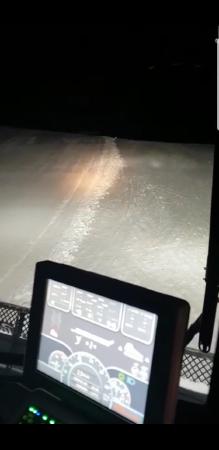 snow cat bringing members back to hut after dark